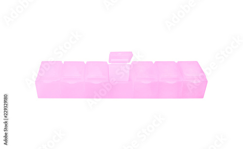 Seven day pill light pink plastic box isolated on white background with clipping path photo