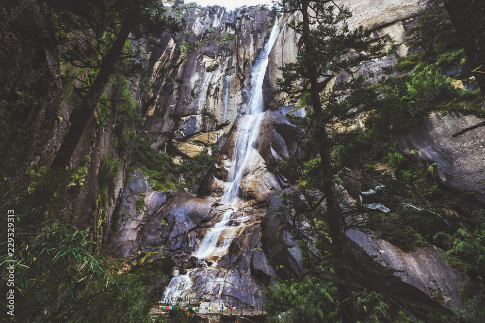 Fototapeta premium Tianfo waterfall in the deep forest of China