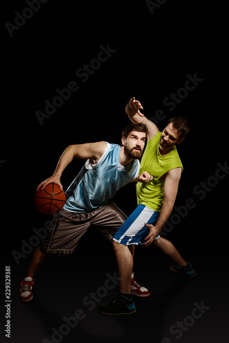 Opponent basketball players in action