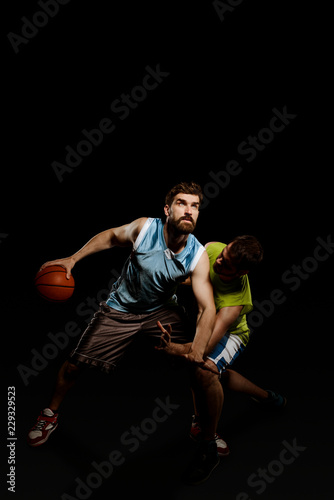 Basketball players isolated on black
