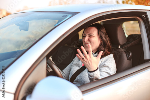 Young woman in a nervous crisis in her car