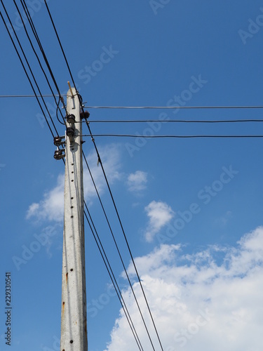 Electric power lines soaring into blue sky