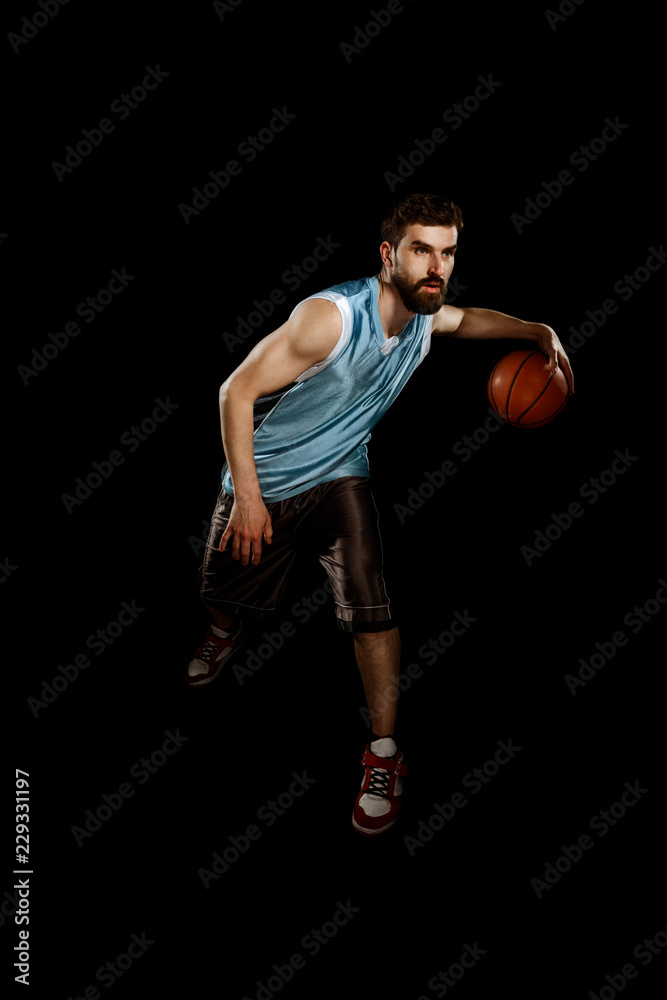 Muscular man dribbling a ball