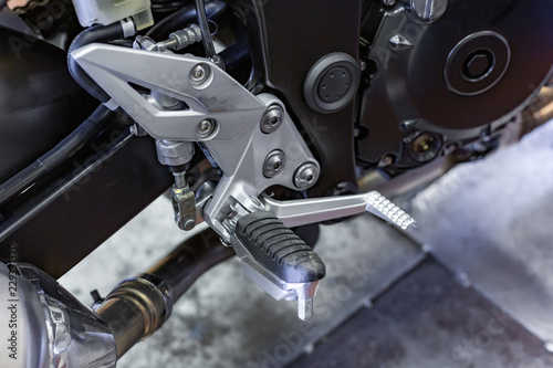 Cropped close up shot of beautiful and custom made motorcycle in the workshop photo