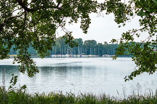 Fotografie Group of catboats docked on horizon on lake Galve in Trakai, Lithuania