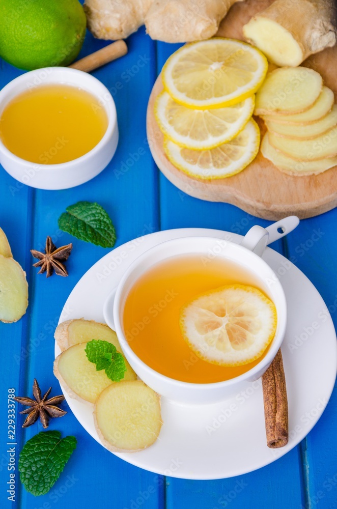 Ginger tea with lemon and honey on blue wooden background Ginger tea with lemon and honey on blue wooden background