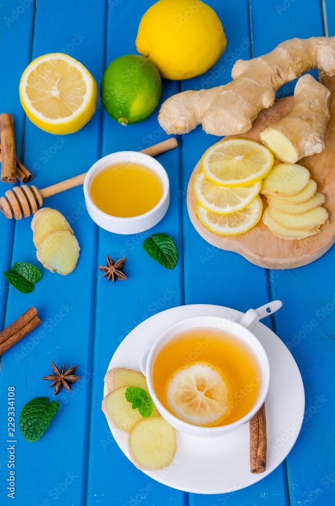 Ginger tea with lemon and honey on blue wooden background Ginger tea with lemon and honey on blue wooden background