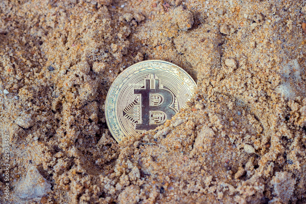 gold coin bitcoin on sand background gold coin bitcoin on sand background