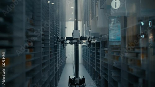 The robot loader work in the pharmacy warehouse. The robot selects the desired product among the many shelves with different products. Novosibirsk, Russia.