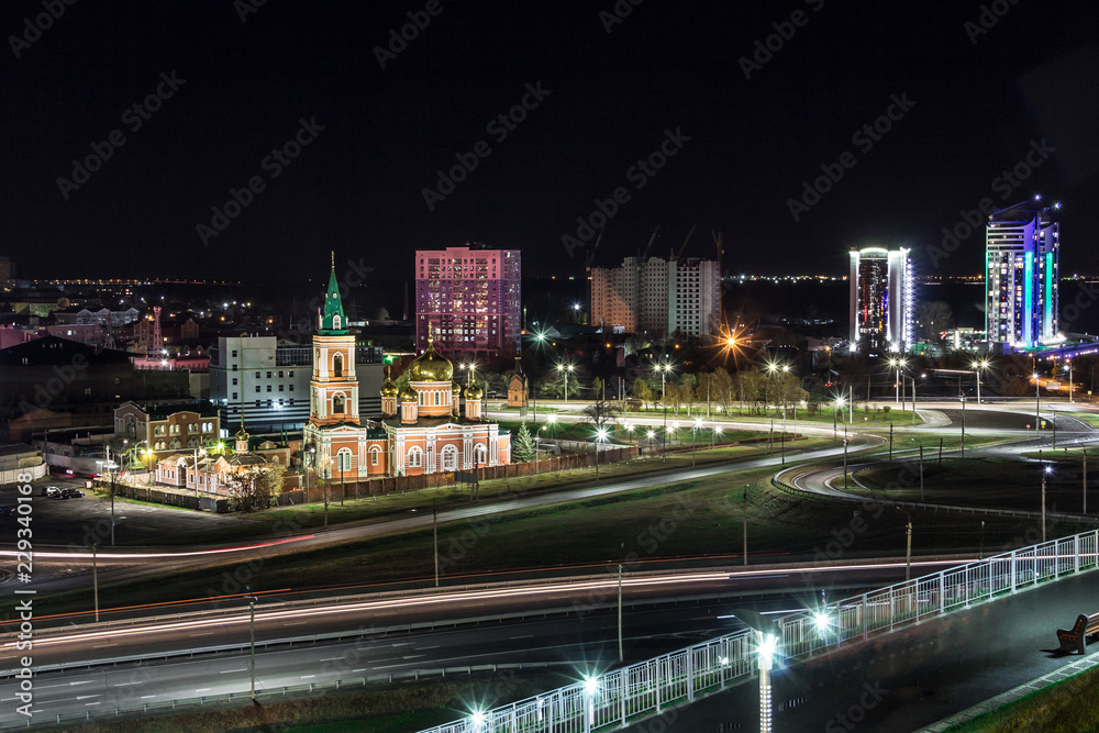The photo shows a piece of night Barnaul and a very beautiful Temple.
