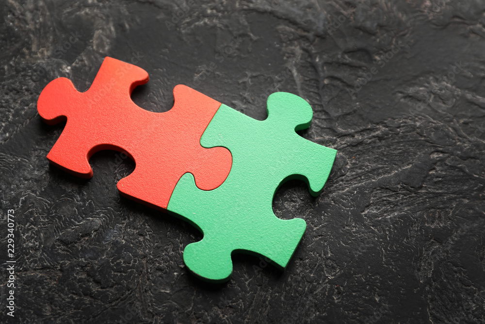 Obraz premium Colorful pieces of puzzle on grey textured background