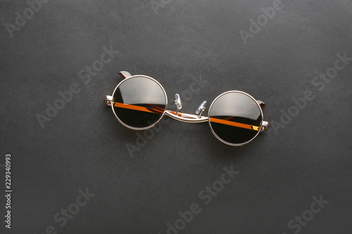 Stylish sunglasses on black background