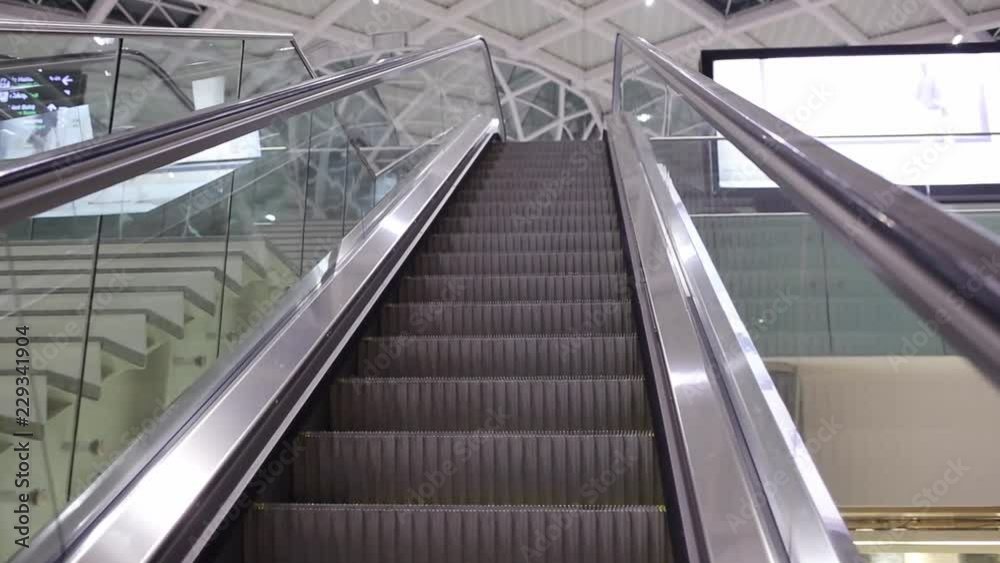 Close-up shot of empty moving staircase running up and down. Modern escalator stairs, which moves indoor. Close-up shot of empty moving staircase running up and down. Modern escalator stairs, which moves indoor.