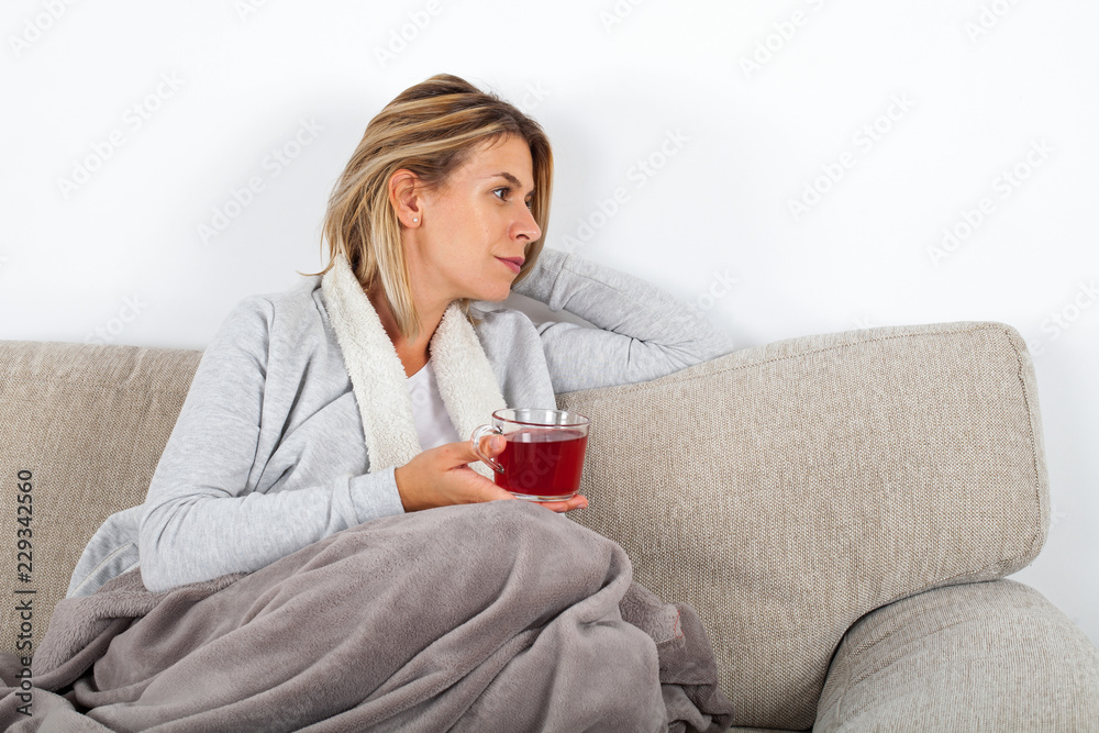 Woman drinking tea on the sofa Woman drinking tea on the sofa