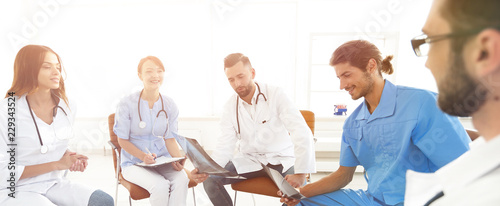 doctors discuss an x-ray ,sitting in the office. © ASDF