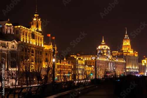 Shanghai boulevard with old ornate western colonial architecture at night time, China