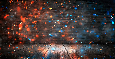 Dark basement room, empty old brick wall, sparks of fire and light on the walls and wooden floor. Dark background with smoke and bright highlights. neon lamps on the wall, night view.