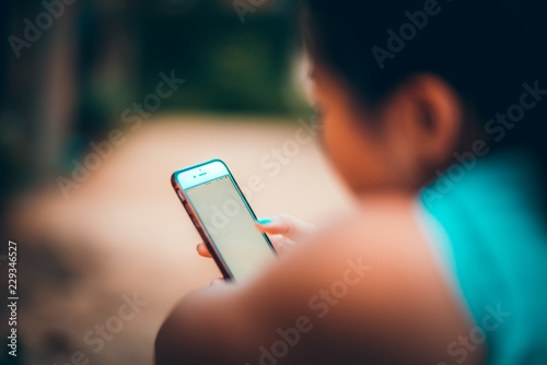 Girl holding phone (ID: 229346527)