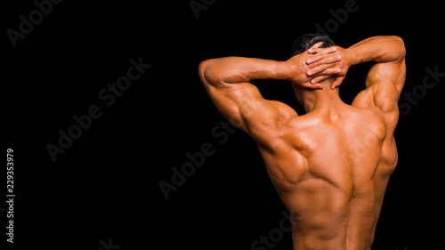 sexy muscle man. Back view. Isolated on dark