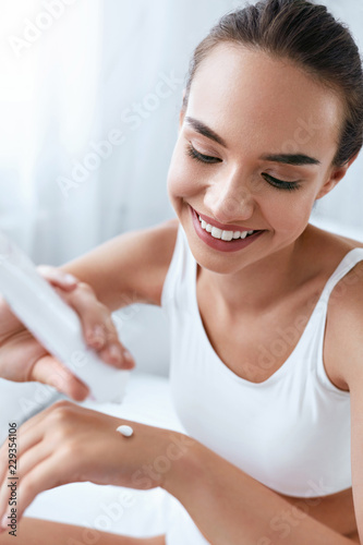 Hand Skin Care. Beautiful Woman Applying Cream On Hands Skin