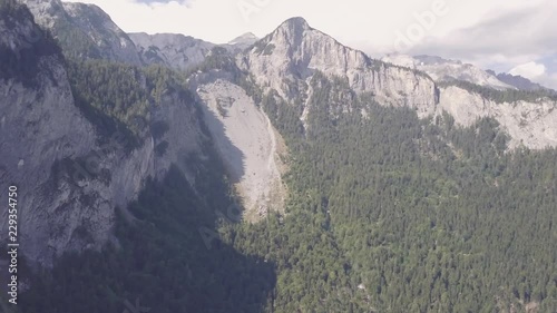 Flying through narrow valleys between high and striking rock walls photo