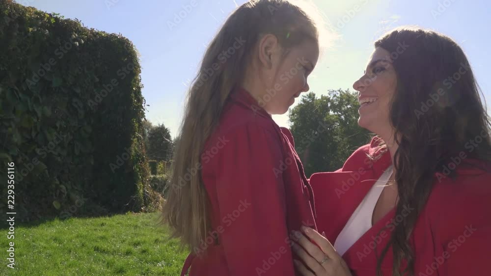 Mom strokes daughter's face Mom strokes daughter's face