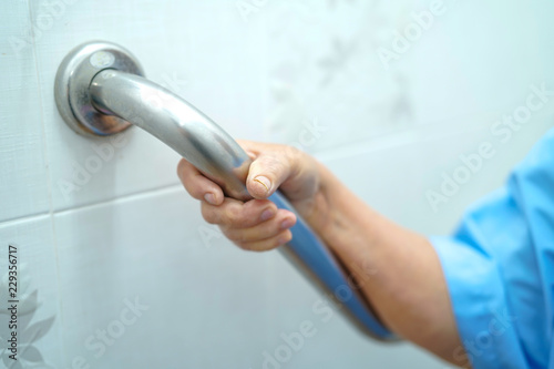 Asian senior or elderly old lady woman patient use toilet handle security in nursing hospital ward : healthy strong medical concept.