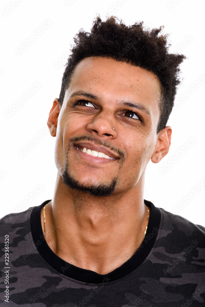 Obraz premium Face of young happy African man smiling while thinking and looki