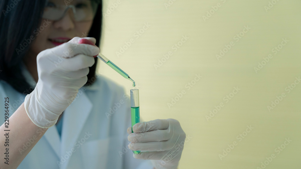 Asian woman scientists are testing different chemicals in the lab Asian woman scientists are testing different chemicals in the lab