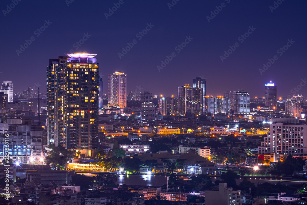 night cityscape in metropolis with river and clear skyline