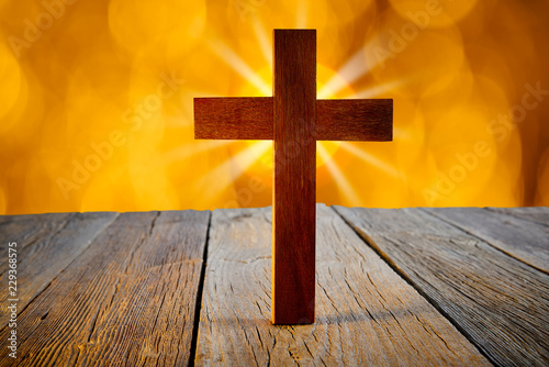 Christian wood cross on blur flare lights