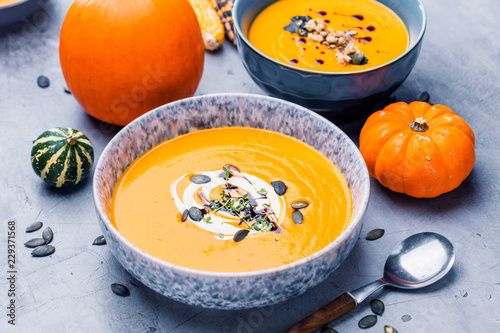 Roasted pumpkin and carrot soup with cream and pumpkin seeds 