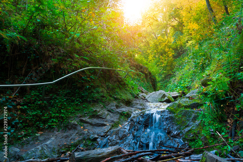 Fototapeta Naklejka Na Ścianę i Meble -  A waterfall in mountain range autumn
