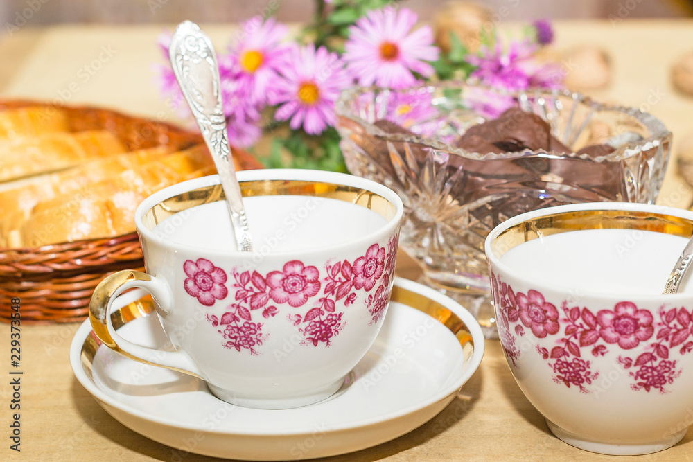 white bread and two teacups on a wooden table white bread and two teacups on a wooden table