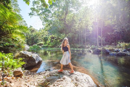 Woman near river among tropical jungle