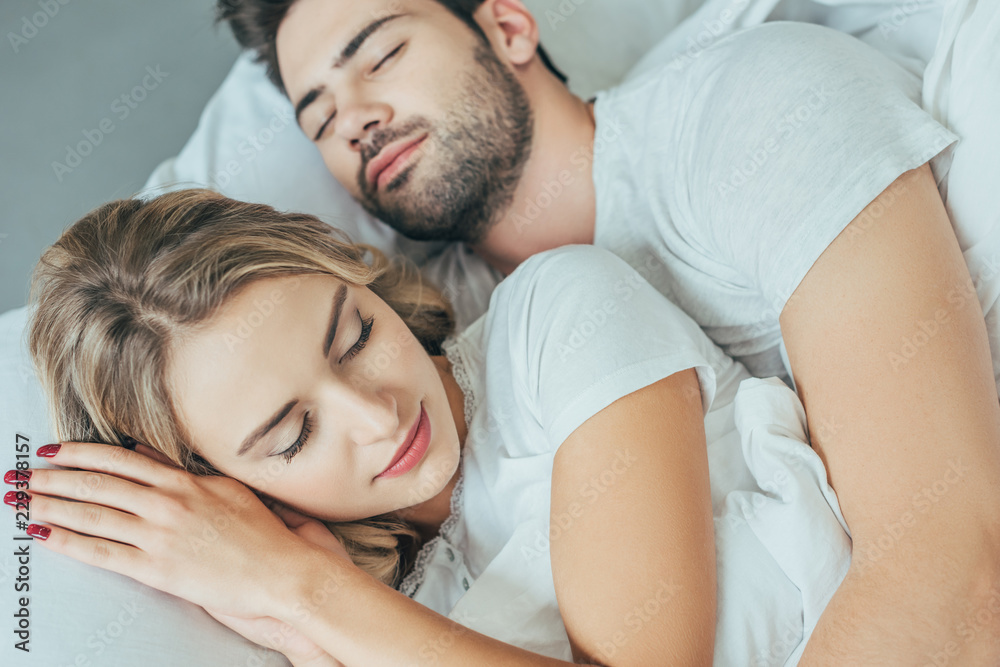 close-up shot of beautiful young couple sleeping together in bed at home close-up shot of beautiful young couple sleeping together in bed at home