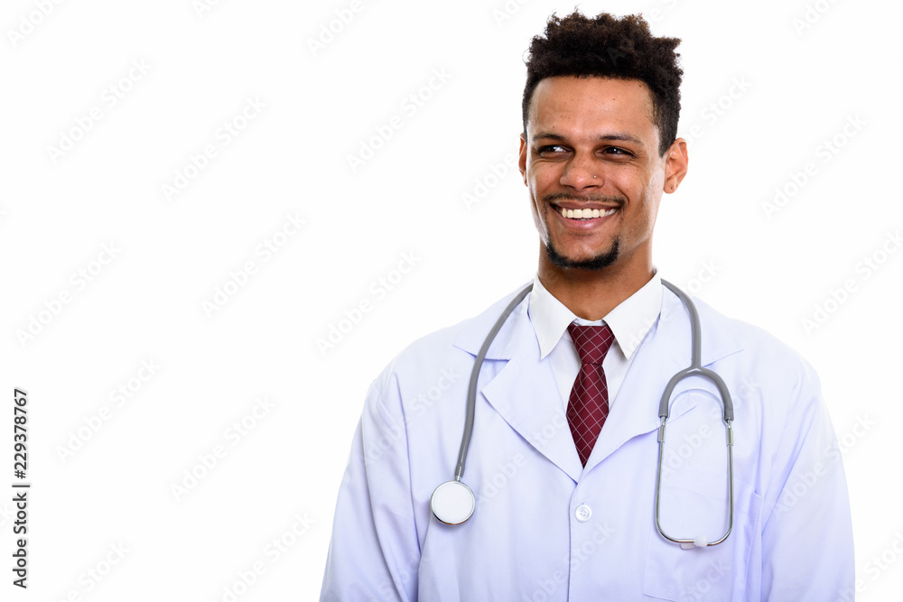 Young happy African man doctor smiling while thinking and lookin Young happy African man doctor smiling while thinking and lookin