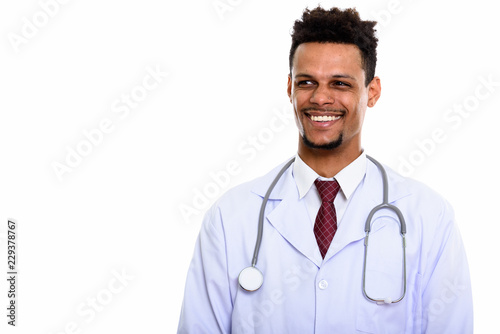 Young happy African man doctor smiling while thinking and lookin