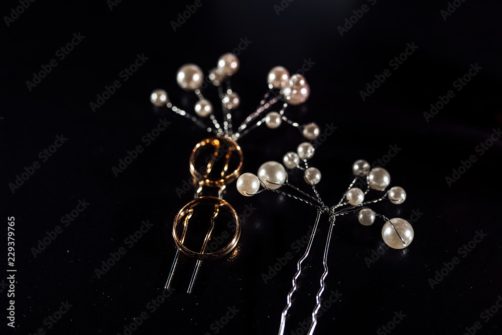 hair clips, wedding rings on black background hair clips, wedding rings on black background