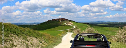 Italy: Small car in tuscan hills. photo