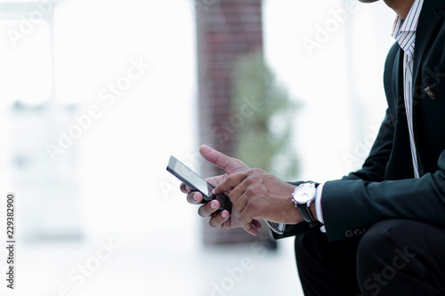 closeup. employee typing SMS on the smartphone