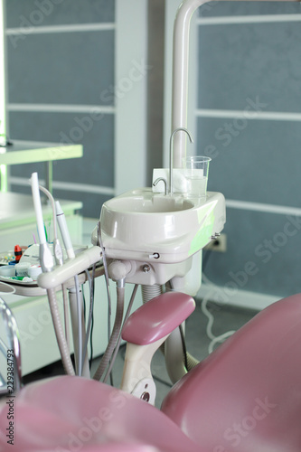 Dental tools near pink chears in the office
