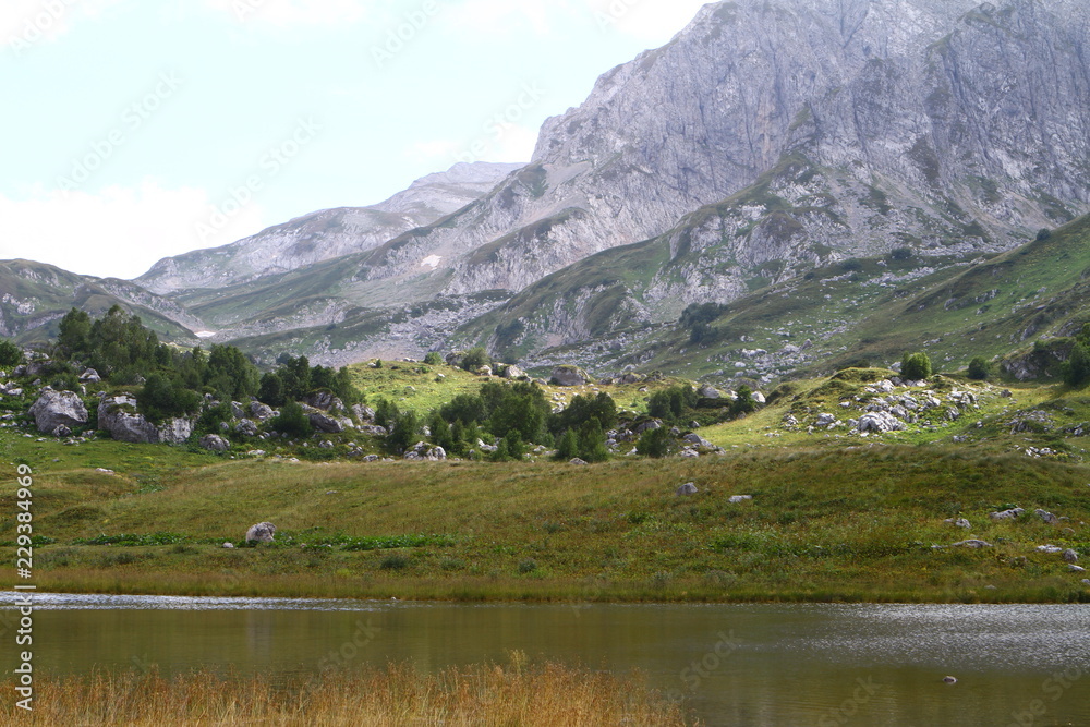Natural landscape photo of small mountain lake Psenodah in North Caucasus at Fisht and Oshten mountains