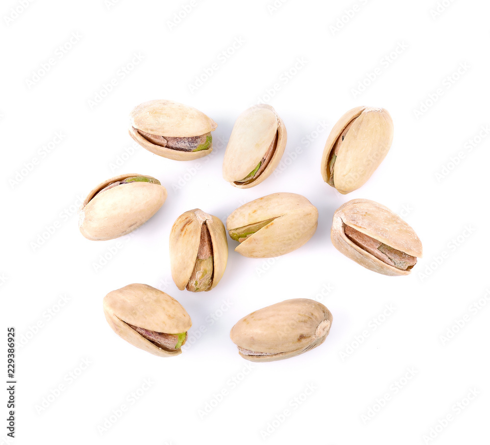 Pistachio nuts on a white background. Pistachio nuts on a white background.