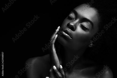 black and white photo of beautiful african american woman isolated on black