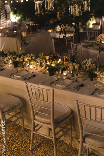 Floral arrangement in a decorated table for a wedding at night with candles