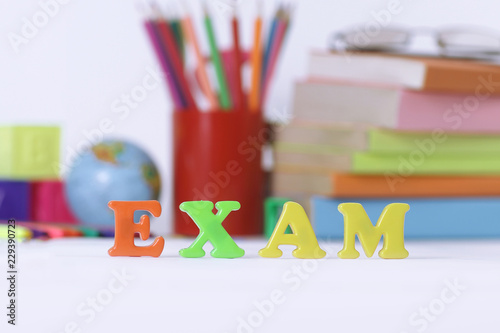 words example on blurred background of school supplies
