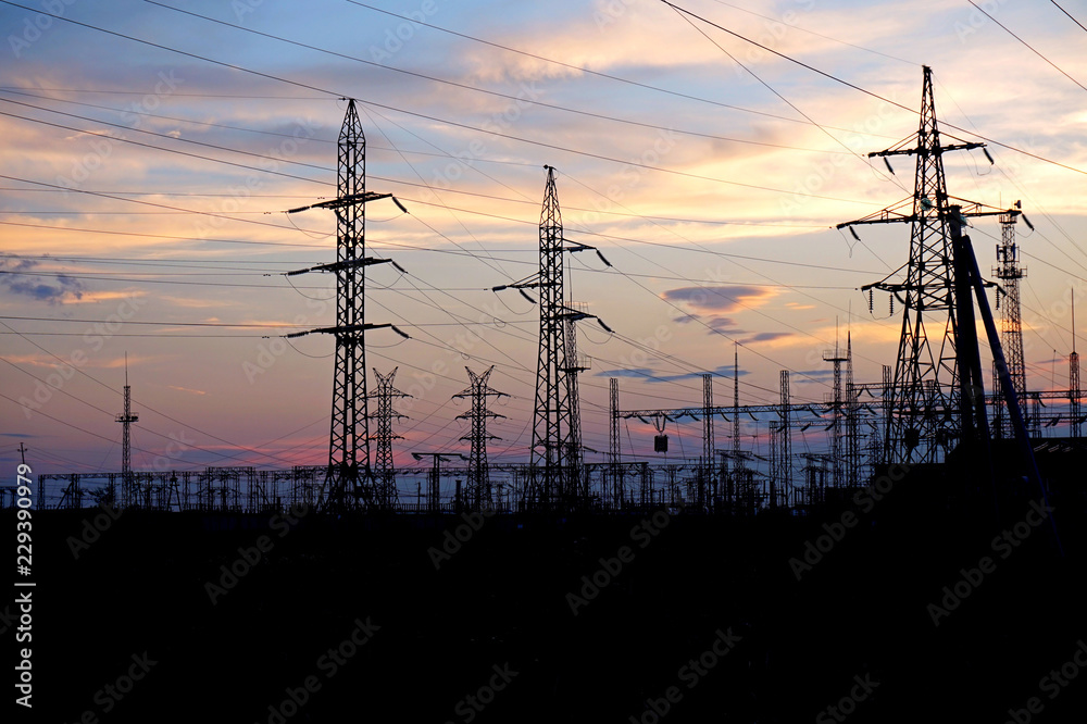 Fototapeta premium Energy. Supports high electricity against the sunset.