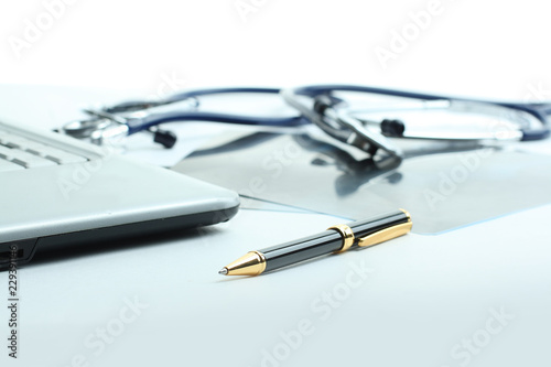 laptop ,stethoscope and x-ray on the table