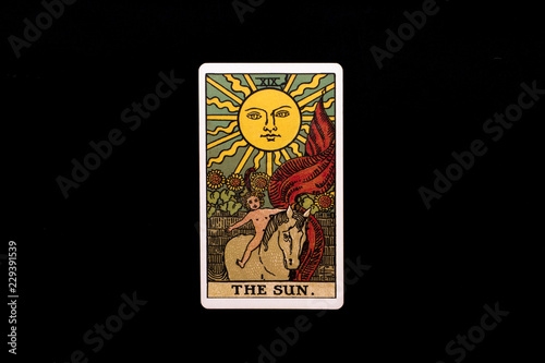 An individual major arcana tarot card isolated on black background. The Sun.